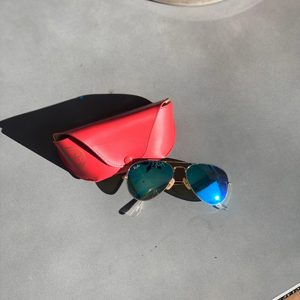 Rayban Aviators with Blue lenses.